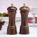 A wooden salt mill and pepper mill set on a table.