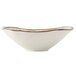 A close-up of a white Tuxton Capistrano bowl with a brown rim.