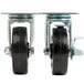 A pair of Avantco metal plate casters with black rubber wheels.