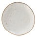 A white Tuxton China bread and butter plate with brown speckles.