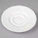 A bright white Tuxton TuxTrendz saucer with a scalloped edge.