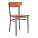 A Lancaster Table & Seating metal chair with an antique walnut wood seat and back.