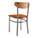 A Lancaster Table & Seating Boomerang chair with a wood seat and back and metal legs.