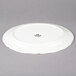 A white Tuxton china oval platter with a scalloped edge.