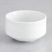 A Tuxton Charleston bright white scalloped edge bowl on a gray surface.