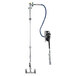 A T&S wall mounted hose reel with a hose attached to a metal pipe.