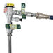 The wall mounted T&S hose reel with a metal pipe and valve on it.