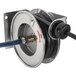 A T&S wall mounted hose reel with a hose attached to it.