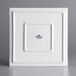 A white square plate with a black square on it.