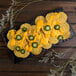 A plate of Martin's yellow round corn tortilla chips with cheese and jalapenos.