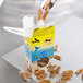 A yellow Beach Window Candy Box filled with caramel candies.