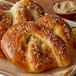 Two freshly baked pretzels on a white tray.