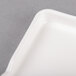 A white rectangular porcelain platter with a handle.