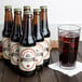 A close-up of a Reading Soda Works Root Beer bottle next to a glass of brown liquid.