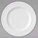 A white Arcoroc porcelain banquet plate with swirls on it.