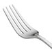 An Oneida Astragal stainless steel dinner fork with a silver handle.