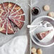 A Pellman raspberry cheesecake with a slice cut out on a plate.