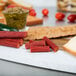 Weaver's Mild Beef Sticks and cheese and meat on a cutting board.