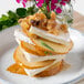 A plate of food with slices of Eiffel Tower Brie cheese and fruit.