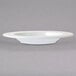 An Arcoroc white porcelain soup bowl on a white background.