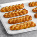 A white tray of 6 Dutch Country Foods Pennsylvania Dutch Soft Pretzel Braids.