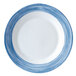 A close-up of a Arcoroc blue and white striped soup plate.