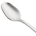 A Oneida Astragal stainless steel demitasse spoon with a silver handle.