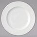 A white porcelain brunch plate with a wavy design on it.