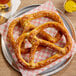 Two Dutch Country Foods Pennsylvania Dutch soft pretzels on a plate.