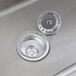 A close-up of a Regency stainless steel multi-station sink with a drain.