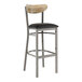 A Lancaster Table & Seating bar stool with a black vinyl seat and driftwood back.