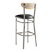 A Lancaster Table & Seating bar stool with a black vinyl seat and driftwood back with chrome legs.