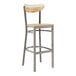 A Lancaster Table & Seating bar stool with a clear coat driftwood seat and back on a metal frame.