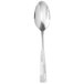A silver serving spoon with a curved white handle.