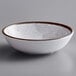 A white Elite Global Solutions melamine bowl with a brown rim.