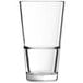 An Arcoroc customizable stackable beverage glass filled with water on a white background.