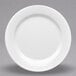 A close-up of a white Elite Global Solutions round rim melamine plate.