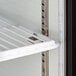 An Avantco countertop display refrigerator shelf with a metal rack and white background.