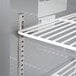 A close-up of a white metal shelf in a Beverage-Air worktop refrigerator.