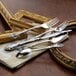 A close-up of a Oneida Michelangelo stainless steel salad fork on a napkin.