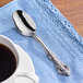 A Oneida Michelangelo stainless steel teaspoon on a napkin.