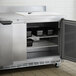 A Beverage-Air stainless steel worktop freezer with doors open on a table.