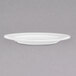 A close up of a Chef & Sommelier white bone china bread and butter plate with a rim.