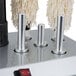 A Campus Products GP5 Silver StemshinePro glass polishing machine with a white cloth on top.