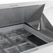 A white Beverage-Air refrigerated sandwich prep table on a counter with trays inside.