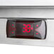 A digital display on a silver Beverage-Air worktop refrigerator.