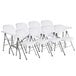 A group of white Lancaster Table & Seating folding chairs.