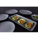 A Tenaya granite stone melamine plate with food on it on a table.