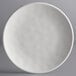 An Elite Global Solutions off white melamine plate with a small amount of food on it.