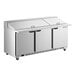 A stainless steel, three-door mega top ADA height refrigerated sandwich prep table with a flat top and casters.